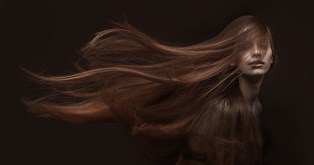 beautiful woman with long hair on dark background