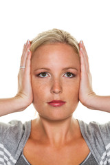Frau hält sich die Ohren zu