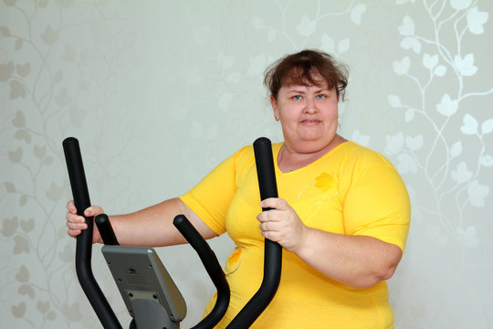 overweight woman exercising on trainer