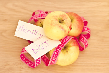 piled apples and measuring tape: eating healthy