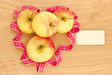 heart made of apples and measuring tape