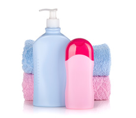 Shampoo and gel bottles with towels