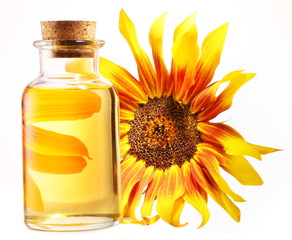 Cooking oil in glass bottle with sunflower on a white background
