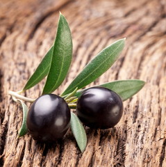 Ripe black olives with leaves.
