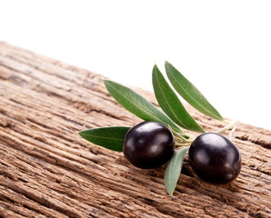 Ripe black olives with leaves.