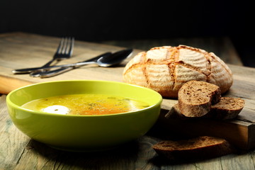 Chicken soup with poached egg .