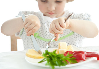 Obraz na płótnie Canvas Little girl eating her dinner