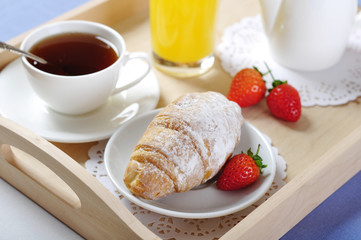 Breakfast with tea and croissants