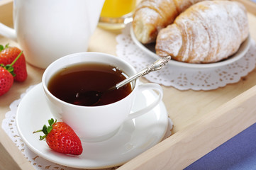 Breakfast with tea and croissants