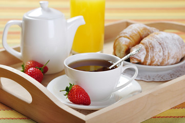 Breakfast with tea and croissants