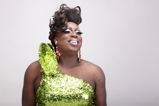 Drag queen wearing a green gown with sequins.