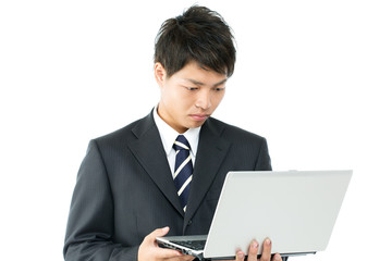 Young asian businessman using a laptop computer
