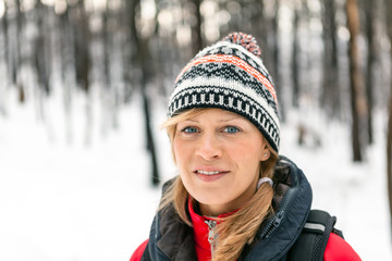 Woman hiking in winter forest