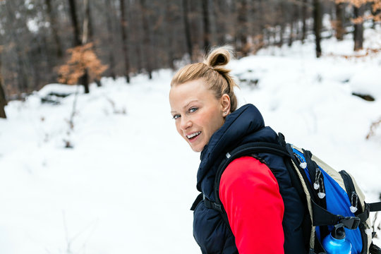 Woman Hiking In Winter Forest