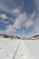 Blue Sky, clouds and snow in a sunny day