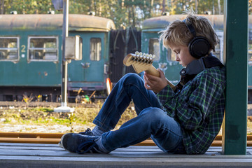 boy with headphone and guitar