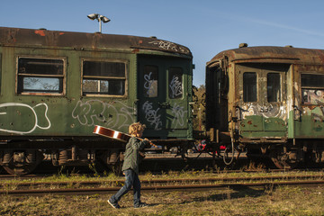 kid walking next to railroad track