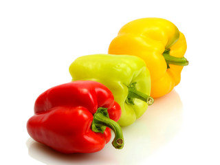 fresh yellow, red and green bell peppers isolated on white