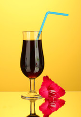 glass with cocktail and gladiolus bud