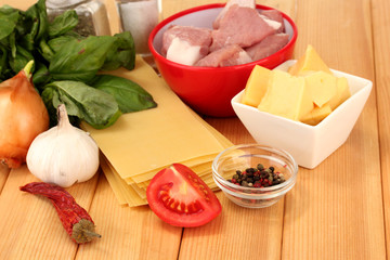 Lasagna ingredients on wooden background