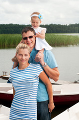 Fototapeta premium Happy family on the river bank