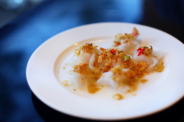 Wonton dumplings served with fried onions and chili, in Vietnam