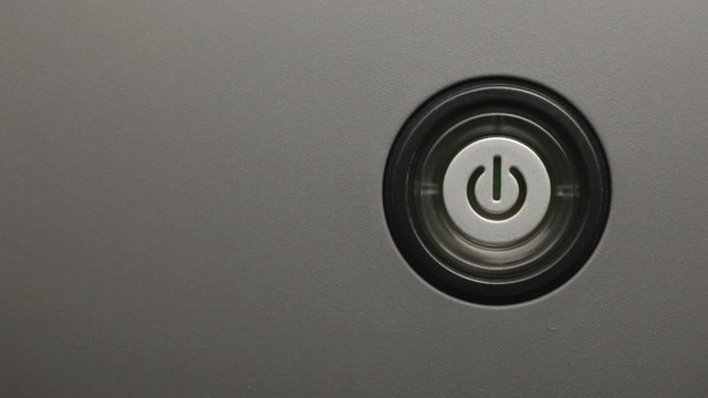 Male index finger turning on a power button