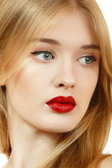 Beautiful woman face with long blond hair and vivid red lipstick