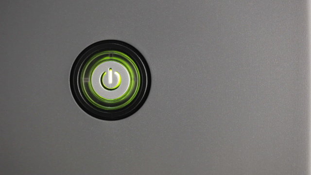 Male index finger turning on a power button