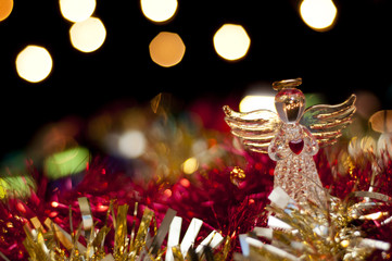 Christmas Angel decoration amidst tinsel and baubles.