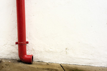 Red gutter in white wall