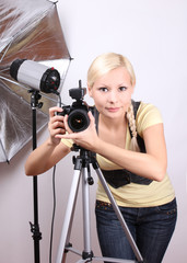 professional photographer,  girl with the camera in photo studio