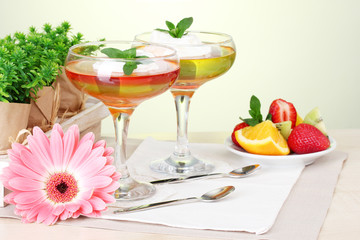 fruit jelly in glasses and fruits on table in cafe