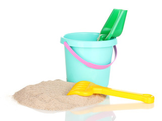Children's beach toys and sand isolated on white