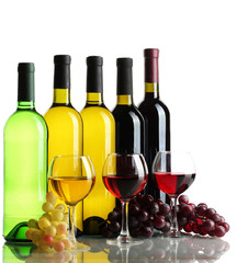bottles and glasses of wine and ripe grapes isolated on white