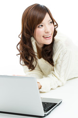 Fototapeta premium Beautiful young woman using a laptop computer. Portrait of asian