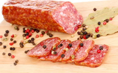 Tasty sausage on chopping board close-up