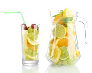 transparent jar and glass with citrus fruits and raspberries,