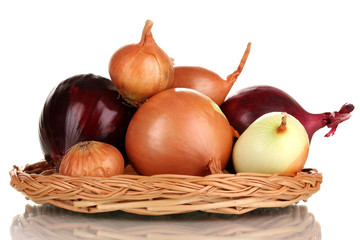 Ripe onions on wicker cradle isolated on white