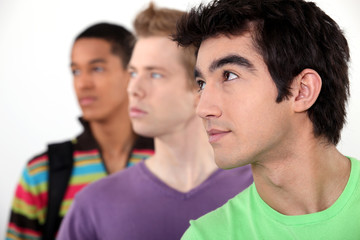 Obraz premium Three male student in line.