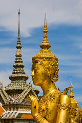 Fototapeta premium Golden statue of Kinnara at Wat Phra Kaew in Bangkok, Thailand