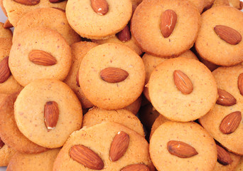 Pile of homemade almond biscuits isolated on white background