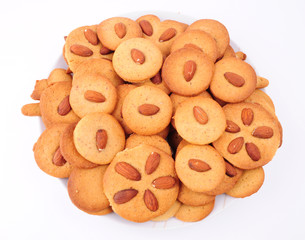 Pile of almond cookies on white background