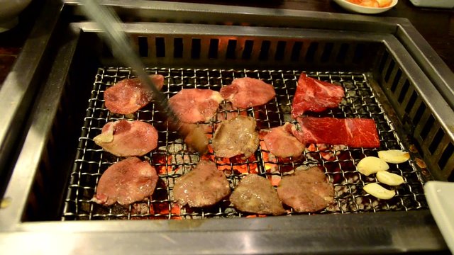 Slice ox tongue and sirlion on hot charcoal grill