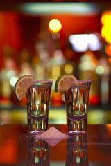 two shots of tequila with lime and salt