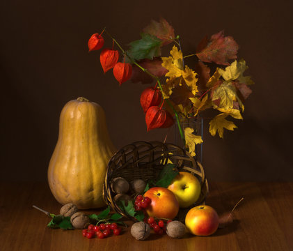still life of pumpkins and apples