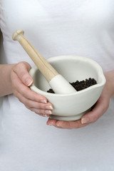 woman pestle and mortar black pepper