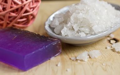 Sea salt and bar of natural handmade soap on wooden  background