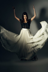 Fototapeta premium attractive woman in flying long skirt