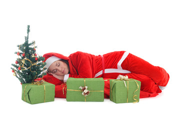 Sleeping santa in red under tree